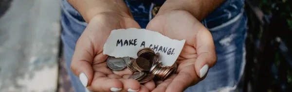 Person holding hand out with money