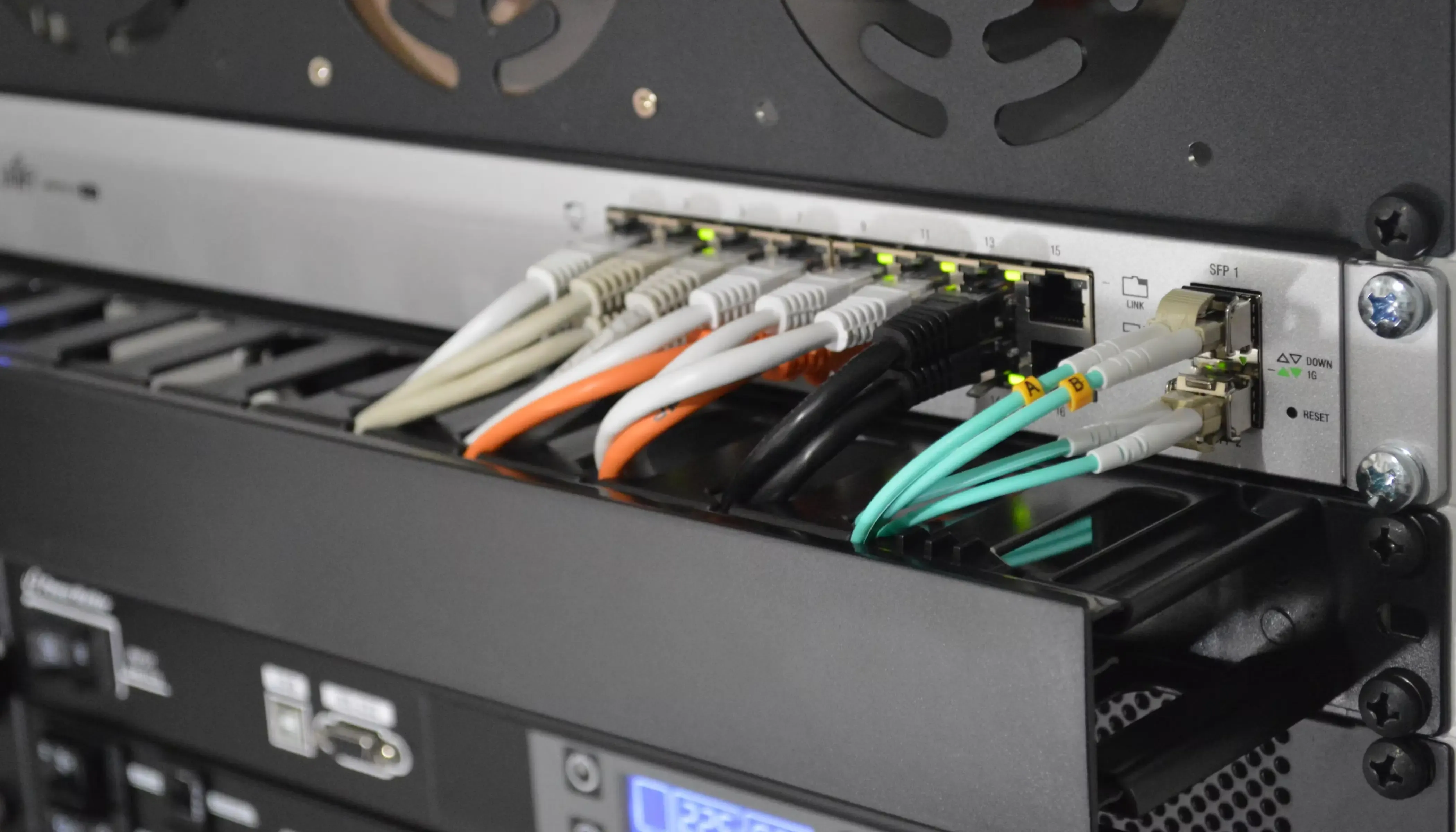 Ethernet & fiber cables connected to Ubiquity router